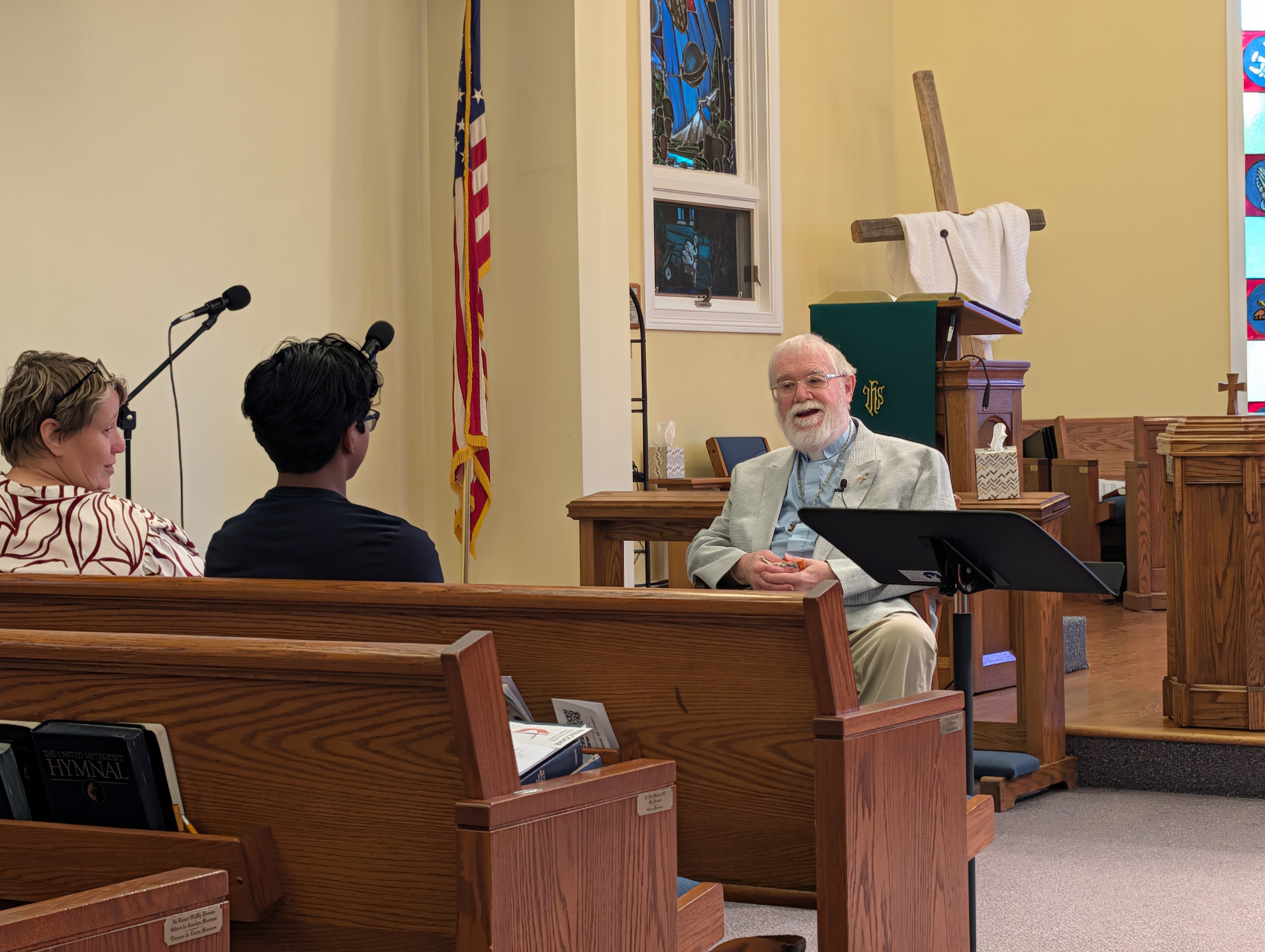 One man preaching to a young teen and woman